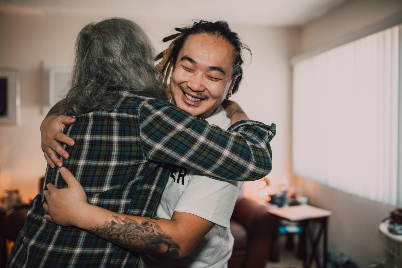 Woman in White T-shirt Hugging Man in Plaid Shirt